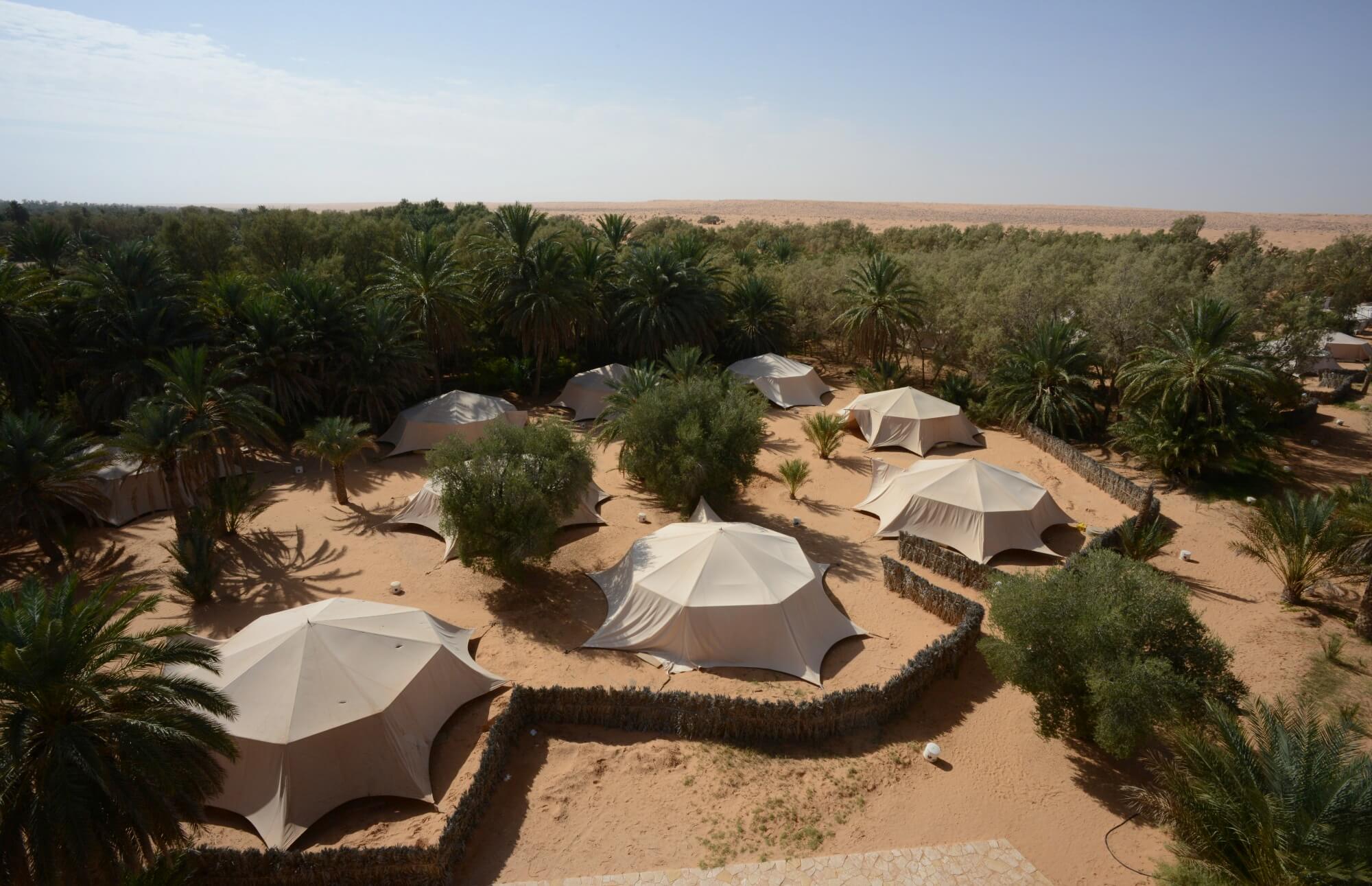 Saharan camp at Ksar Ghilane in Tunisia, traditional tents set up in the heart of the desert.