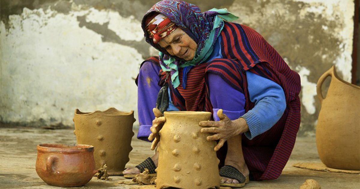 Sejnane woman potter making traditional pottery, classified by UNESCO, a symbol of Tunisian cultural heritage.
