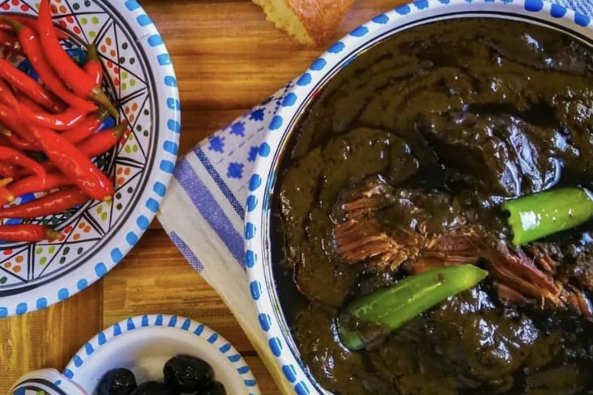Traditional Tunisian mloukhia dish cooked with jute leaf powder and meat