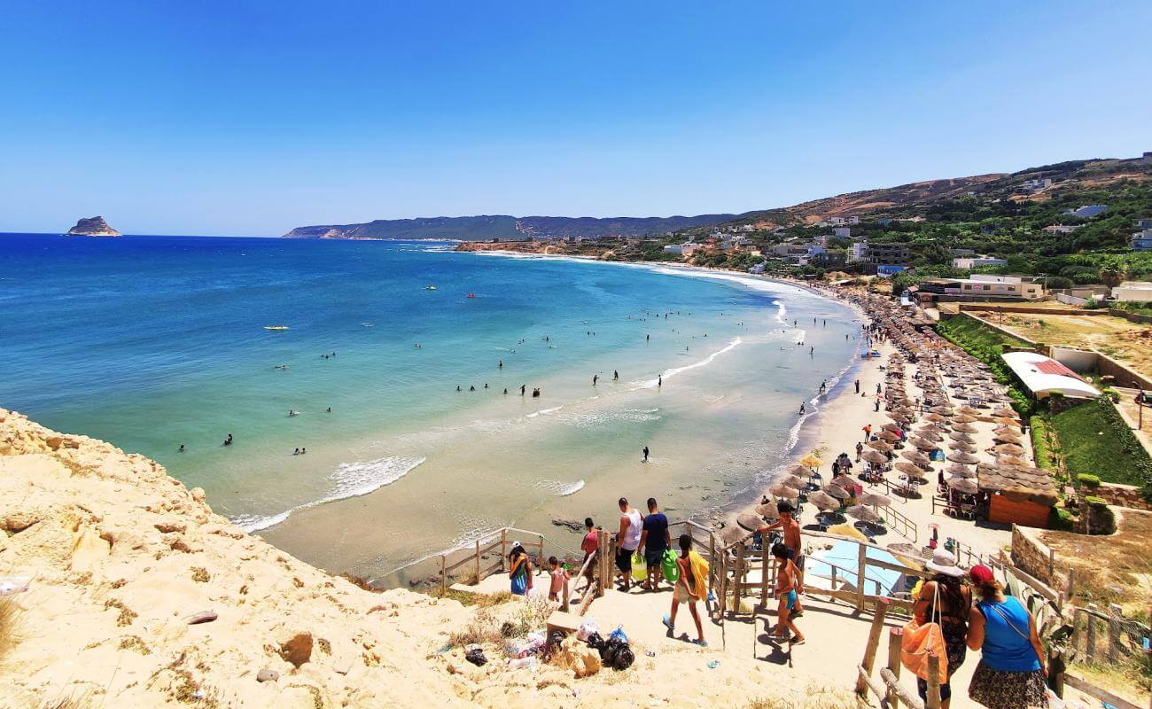 Ain Mestir Beach in Bizerte with turquoise Mediterranean waters, sandy shoreline and natural coastal hills